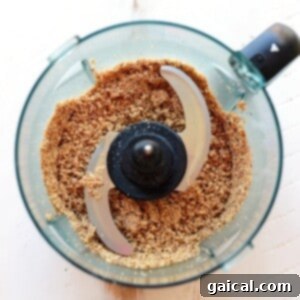 A food processor creating cherry pie energy balls with brown sugar.