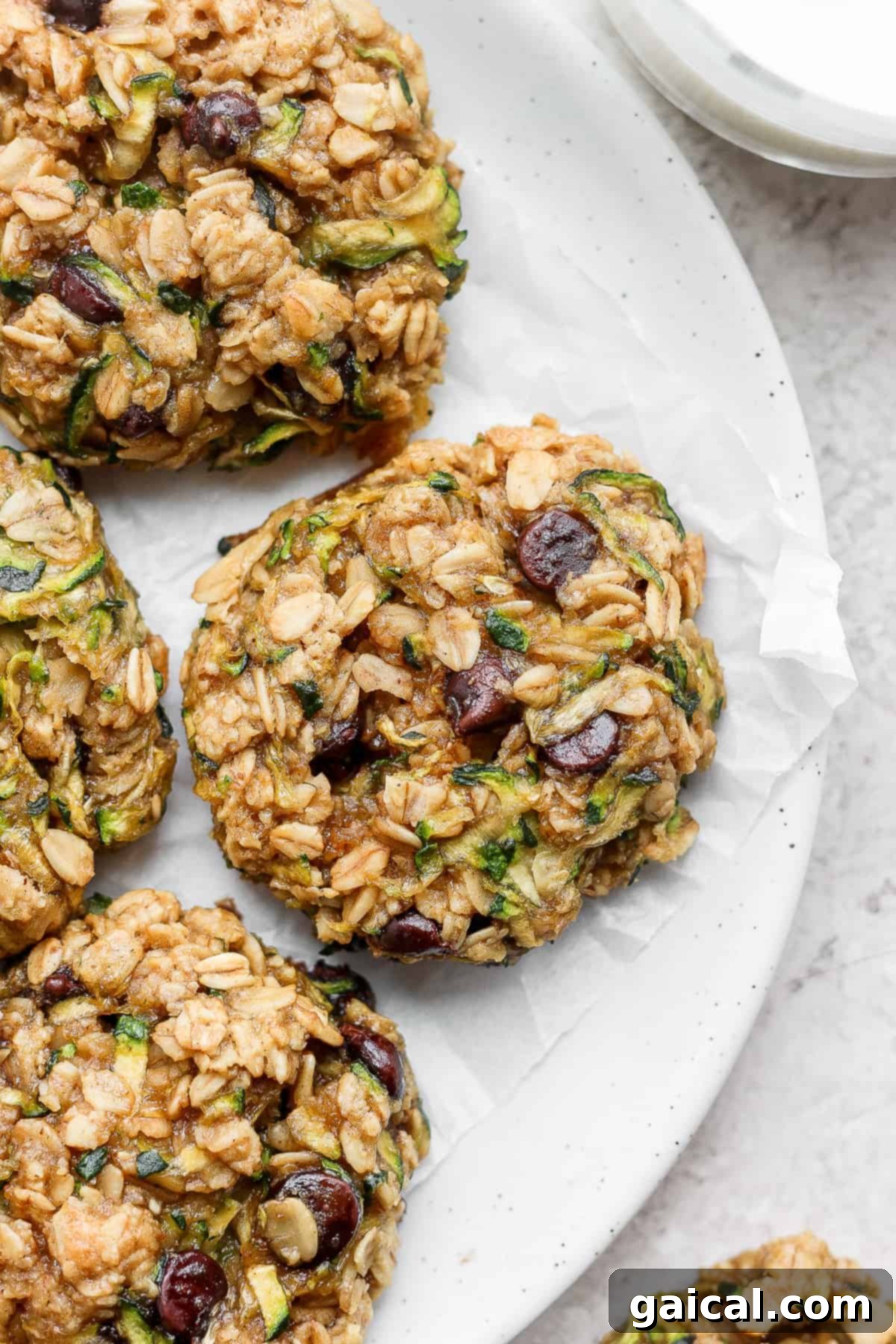 Deliciously soft and chewy zucchini oatmeal cookies on a plate. A plate of freshly baked zucchini oatmeal cookies.