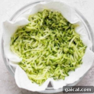 A bowl of shredded zucchini with salt.