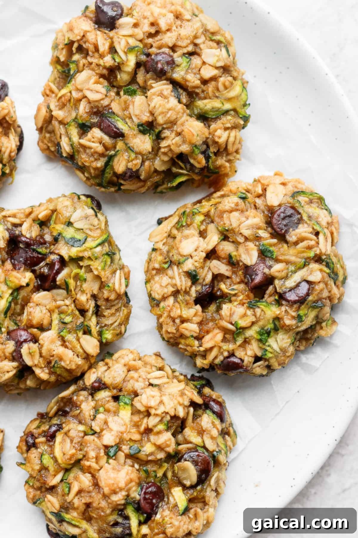 Perfectly baked zucchini oatmeal cookies. A stunning close-up of zucchini oatmeal cookies perfectly arranged on a white plate, showcasing their soft texture and melty chocolate chips.