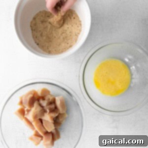 a person adding spices to a bowl of food.