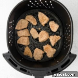 a black basket with brown food in it.