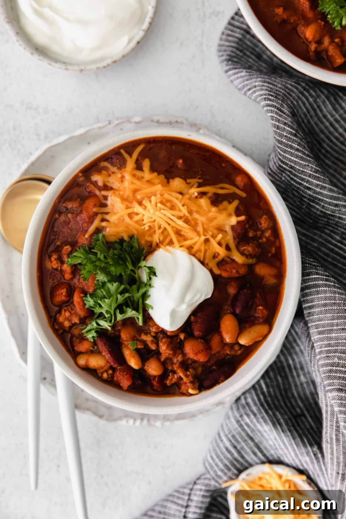 Instant Pot chili topped with shredded cheese in a bowl, ready to be served.