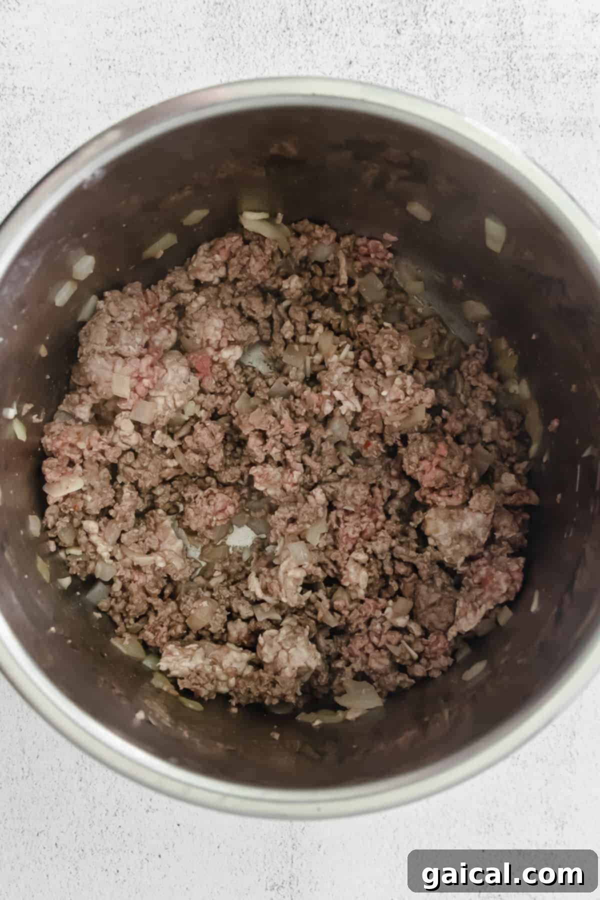 Ground beef browning in the Instant Pot, forming the base of the chili.