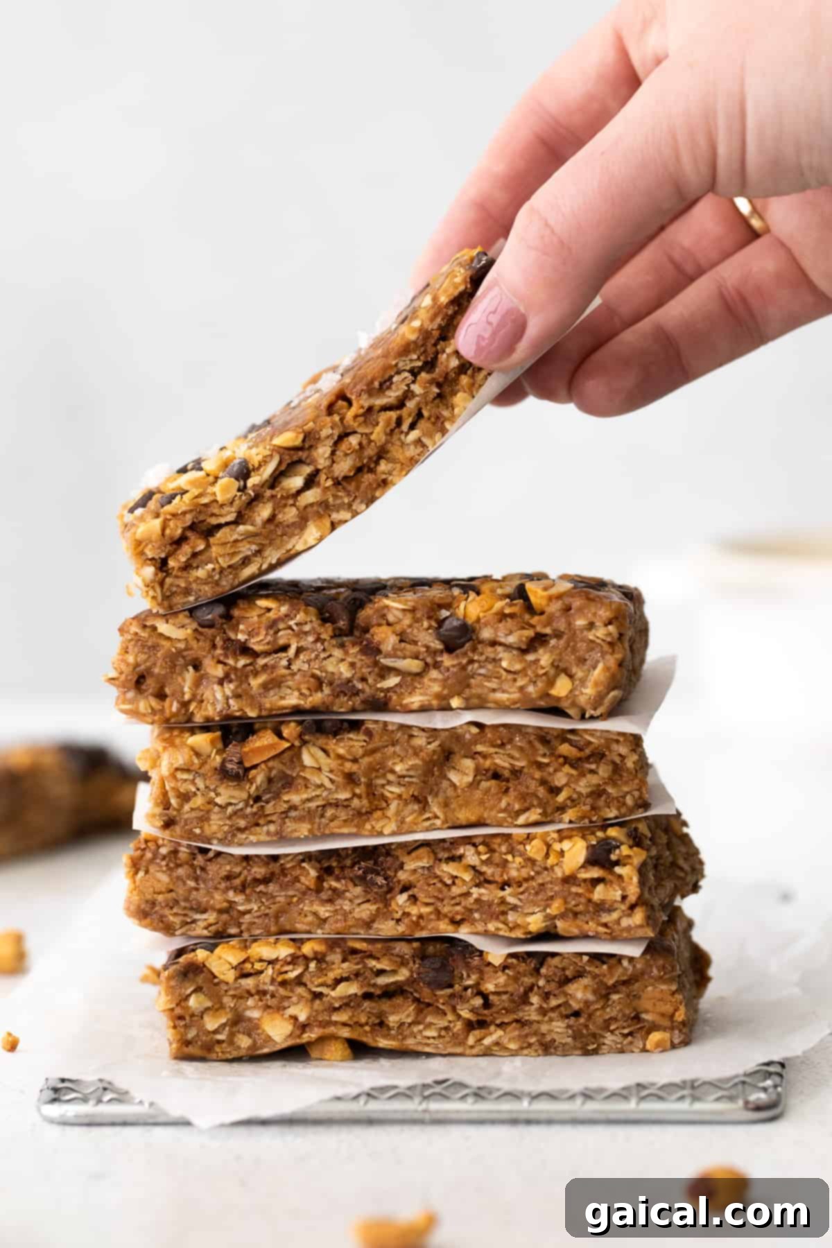 Homemade Peanut Butter Chocolate Chip Granola Bar Ready to Eat A hand holding a perfectly crafted peanut butter chocolate chip granola bar, showcasing its chewy texture and delicious ingredients.
