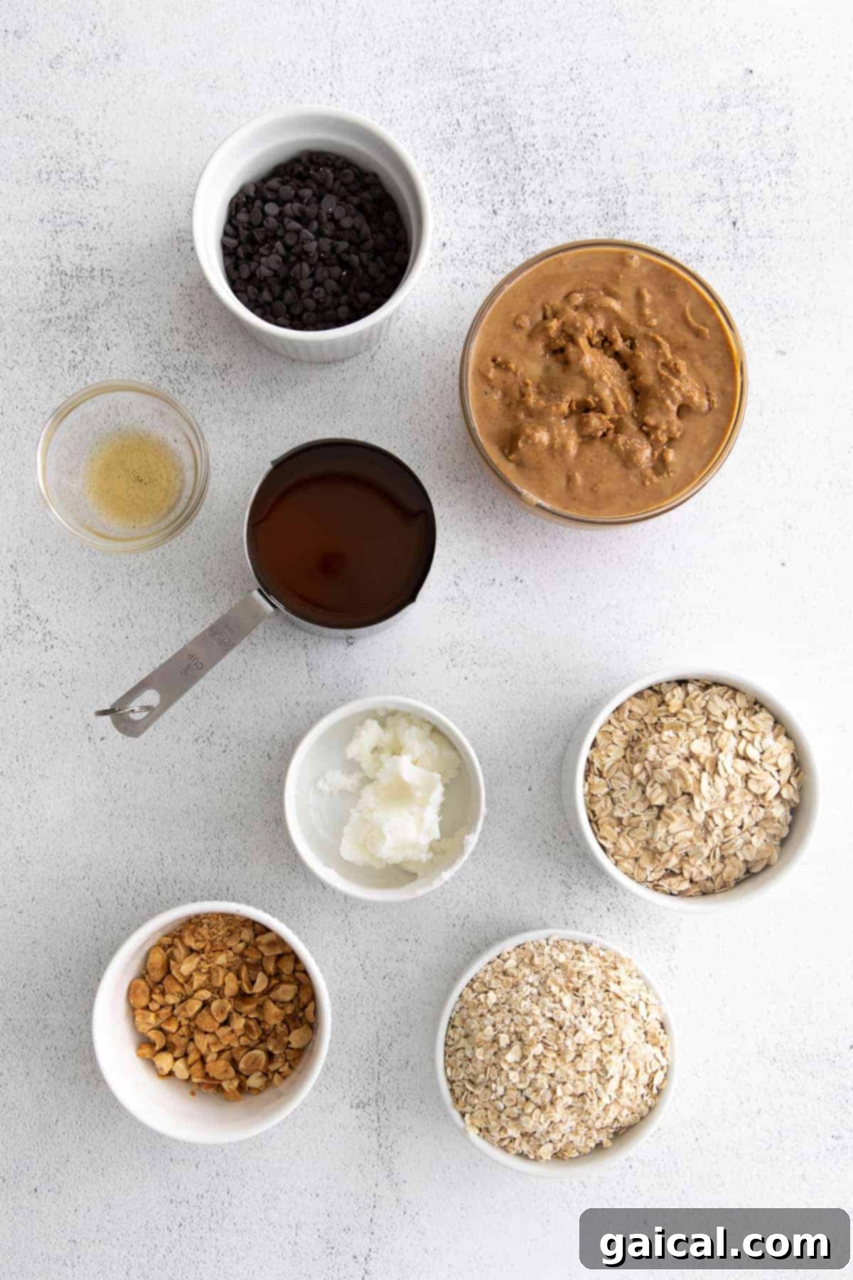 Key Ingredients for Delicious No-Bake Granola Bars Various healthy ingredients like oats, peanut butter, honey, and chocolate chips neatly arranged on a kitchen countertop, ready for making granola bars.