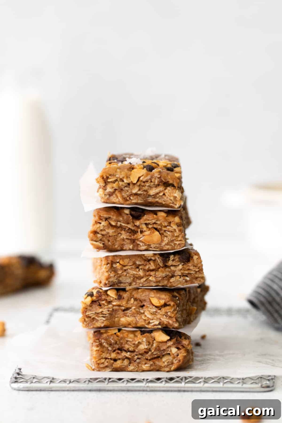 Stacked Homemade Granola Bars Ready for Snacking A stack of perfectly sliced homemade peanut butter chocolate chip granola bars, showcasing their wholesome ingredients and appealing texture.