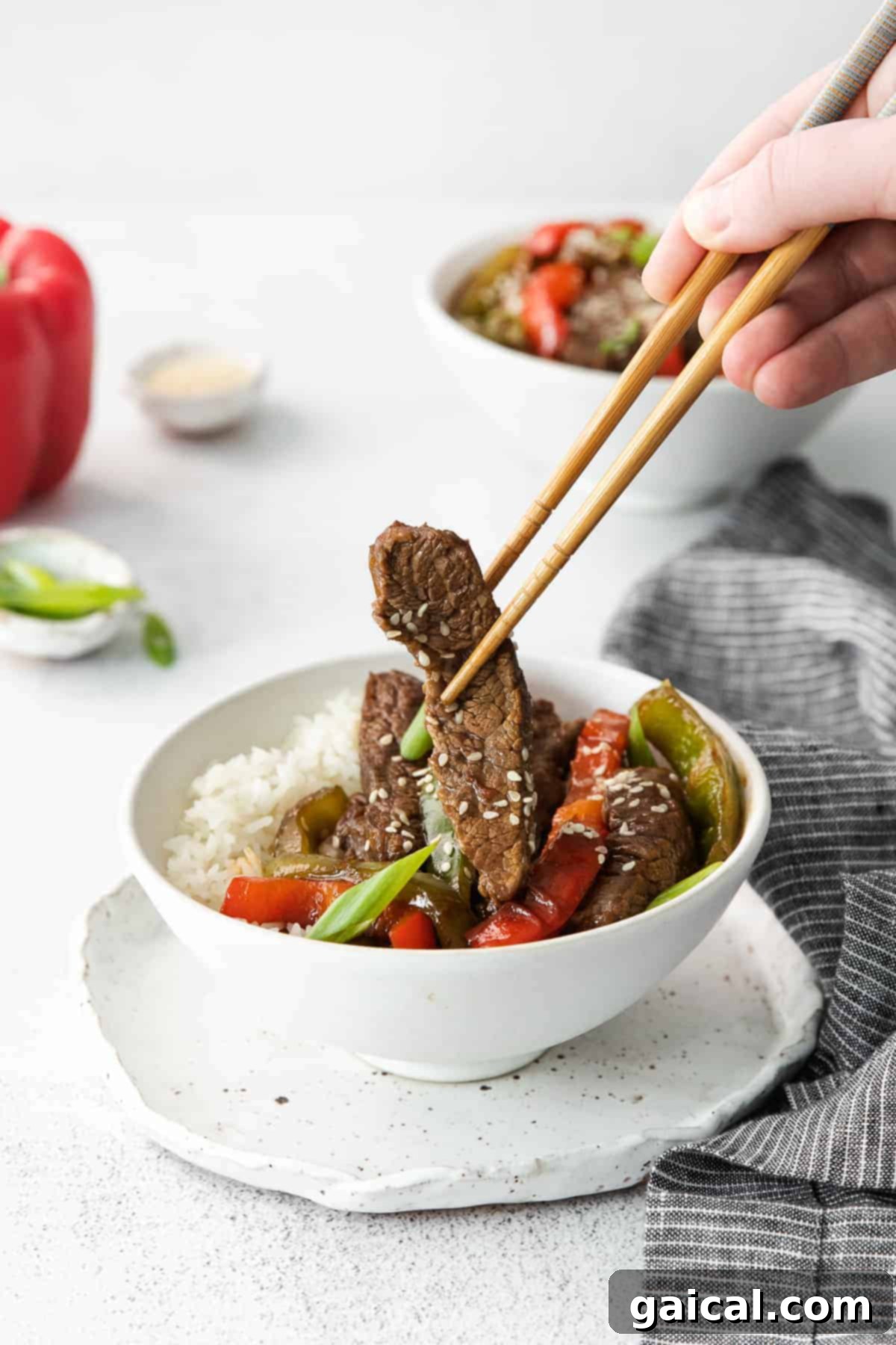 Sizzling Pepper Steak 10 Eating pepper steak with chop sticks.