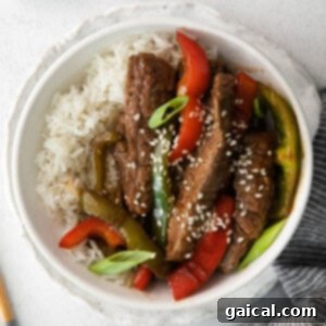 Pepper steak sprinkled with sesame seeds.