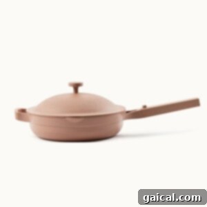 Sizzling Pepper Steak 8 a pan with a handle on a white background.
