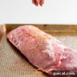 Seasoning ribs with the homemade dry rub for rich flavor.
