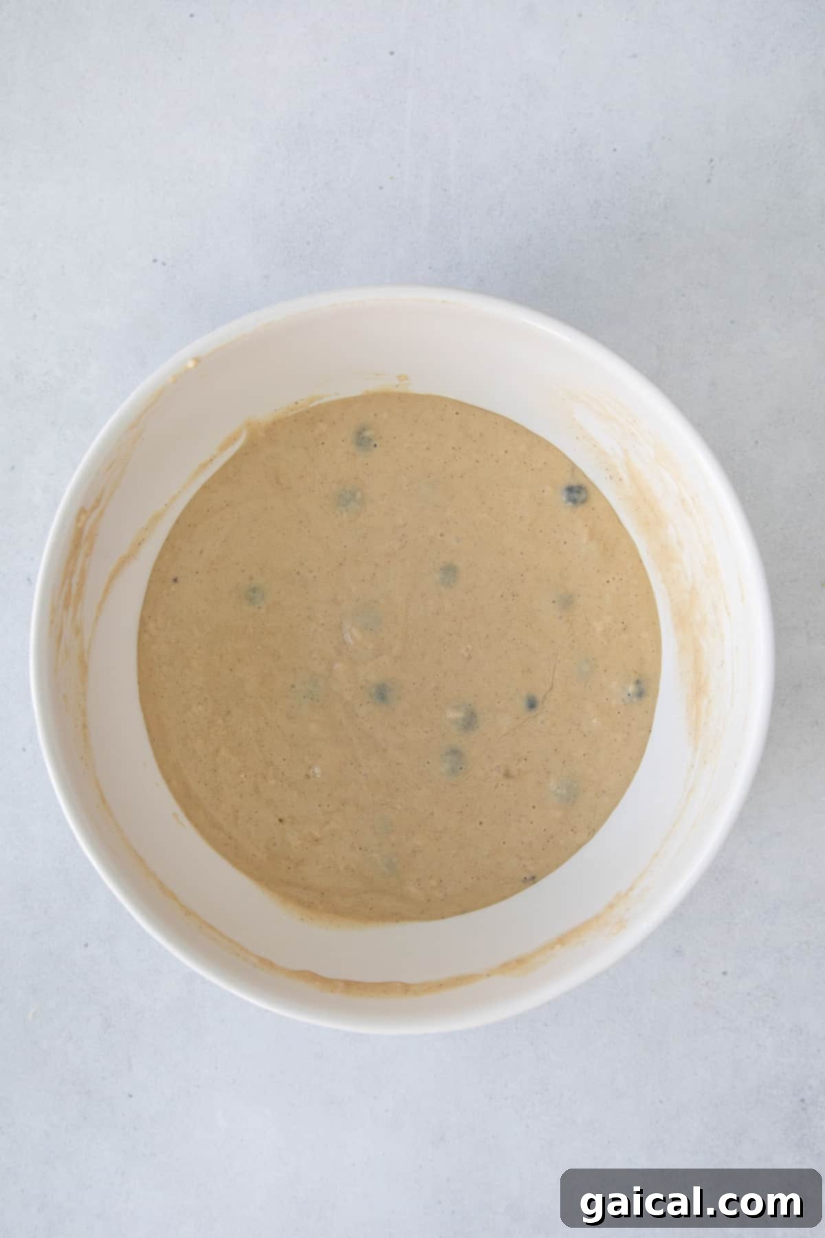 Pancake Batter Ready Pancake batter in a large mixing bowl, perfectly smooth and ready for baking.