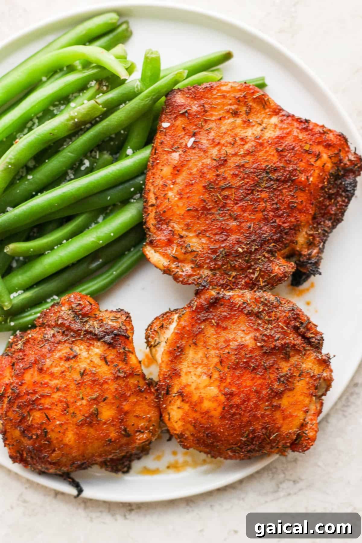Air fryer chicken thighs served with fresh green beans