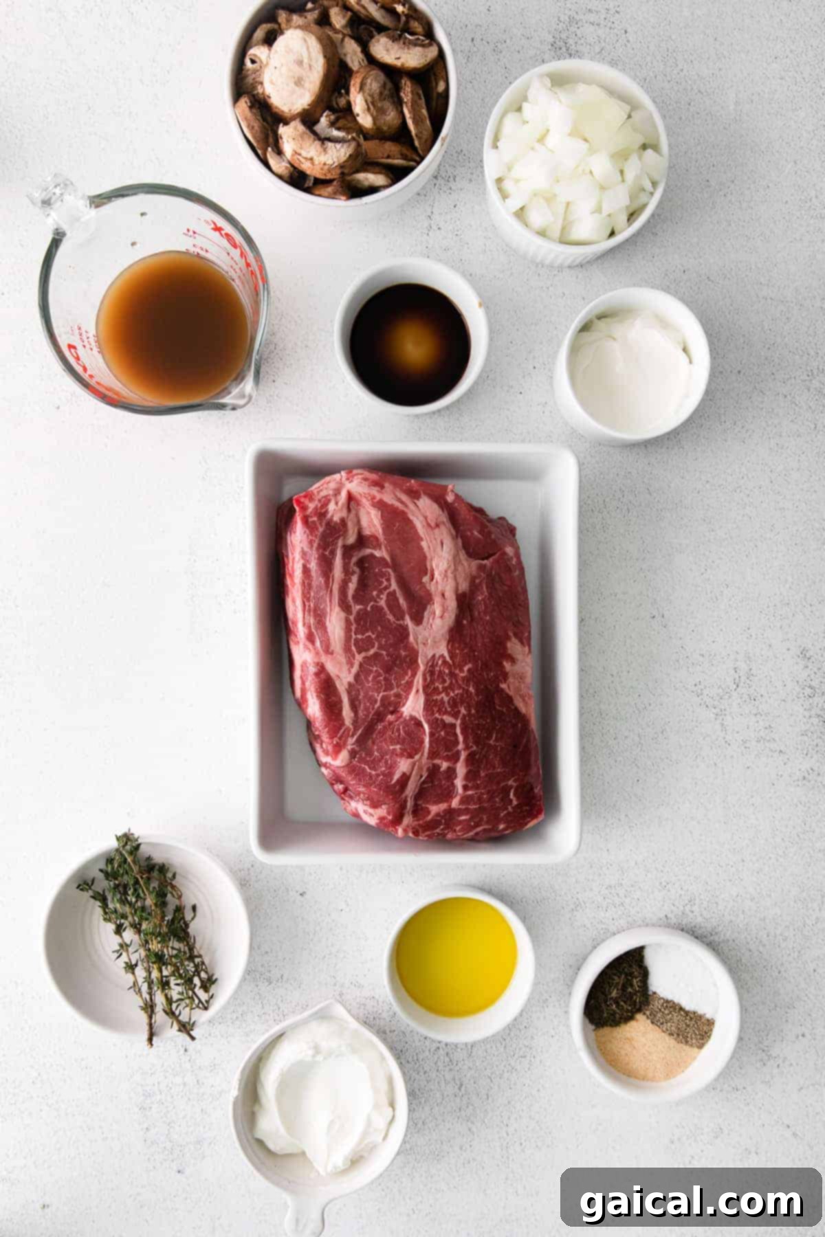 A vibrant collection of fresh ingredients for slow cooker beef stroganoff, neatly arranged in bowls, showcasing quality produce and seasonings.