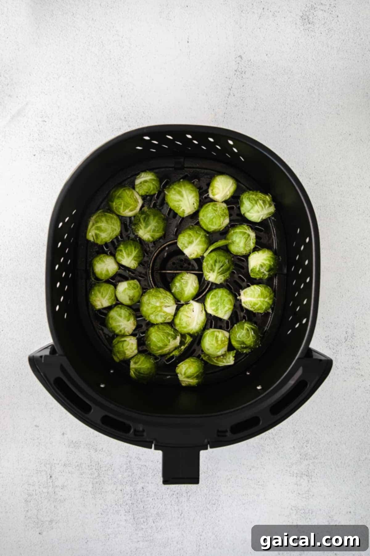 Perfectly Crisp Air-Fried Brussels 4 Brussel sprouts in an air fryer.