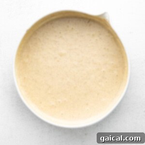 Pancake batter in a bowl with dry and wet ingredients combined.