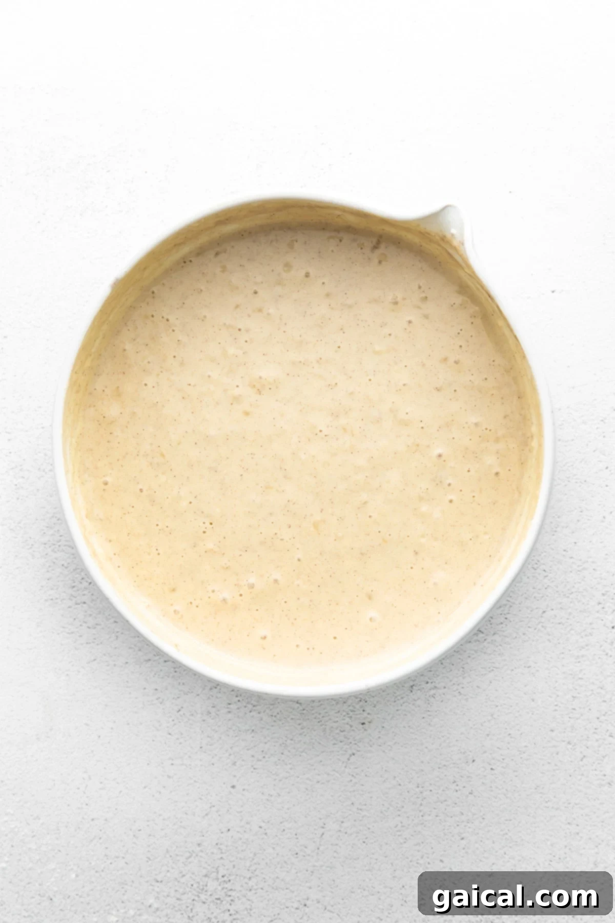 Nourishing Banana Pancakes 5 Thick, wholesome banana pancake batter in a mixing bowl, ready for cooking.