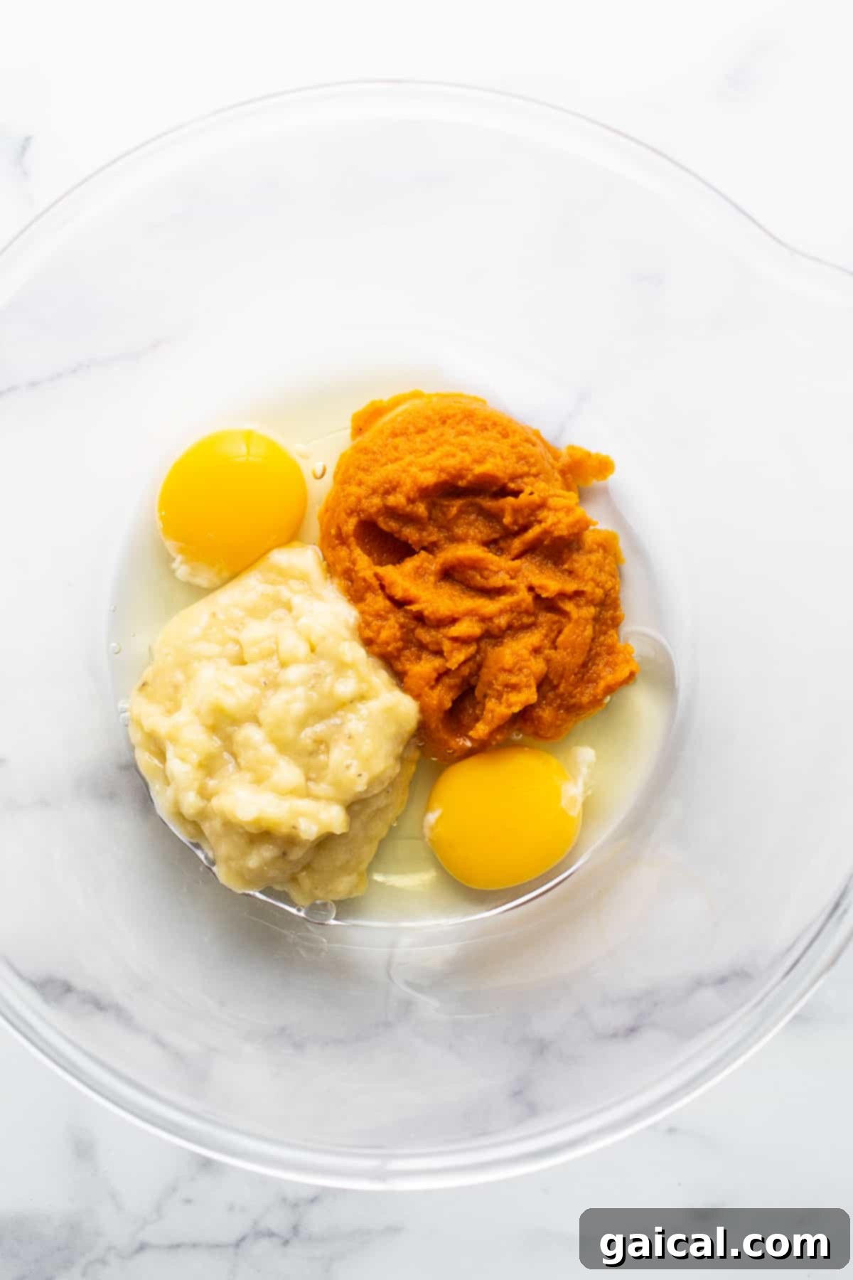Marbled Brown Sugar Pumpkin Breakfast Cake 3 Two eggs and mashed sweet potato in a bowl.