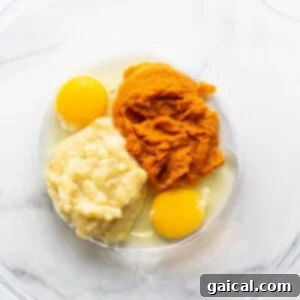 Marbled Brown Sugar Pumpkin Breakfast Cake 8 Two eggs and mashed sweet potato in a bowl.