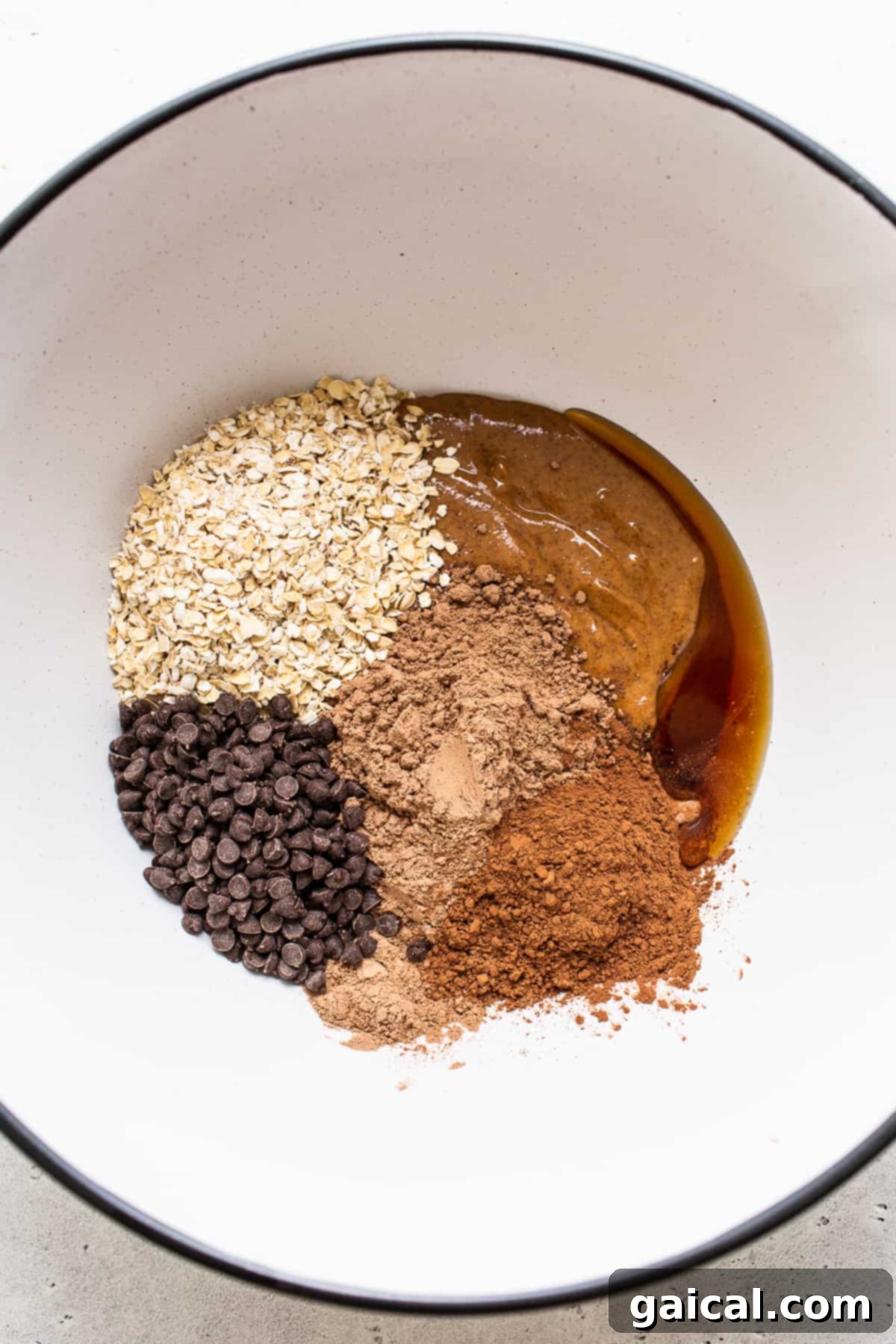 Essential Ingredients for Mint Chip Protein Balls All the dry and wet ingredients for mint chip protein balls placed in separate bowls, ready to be mixed for preparation.