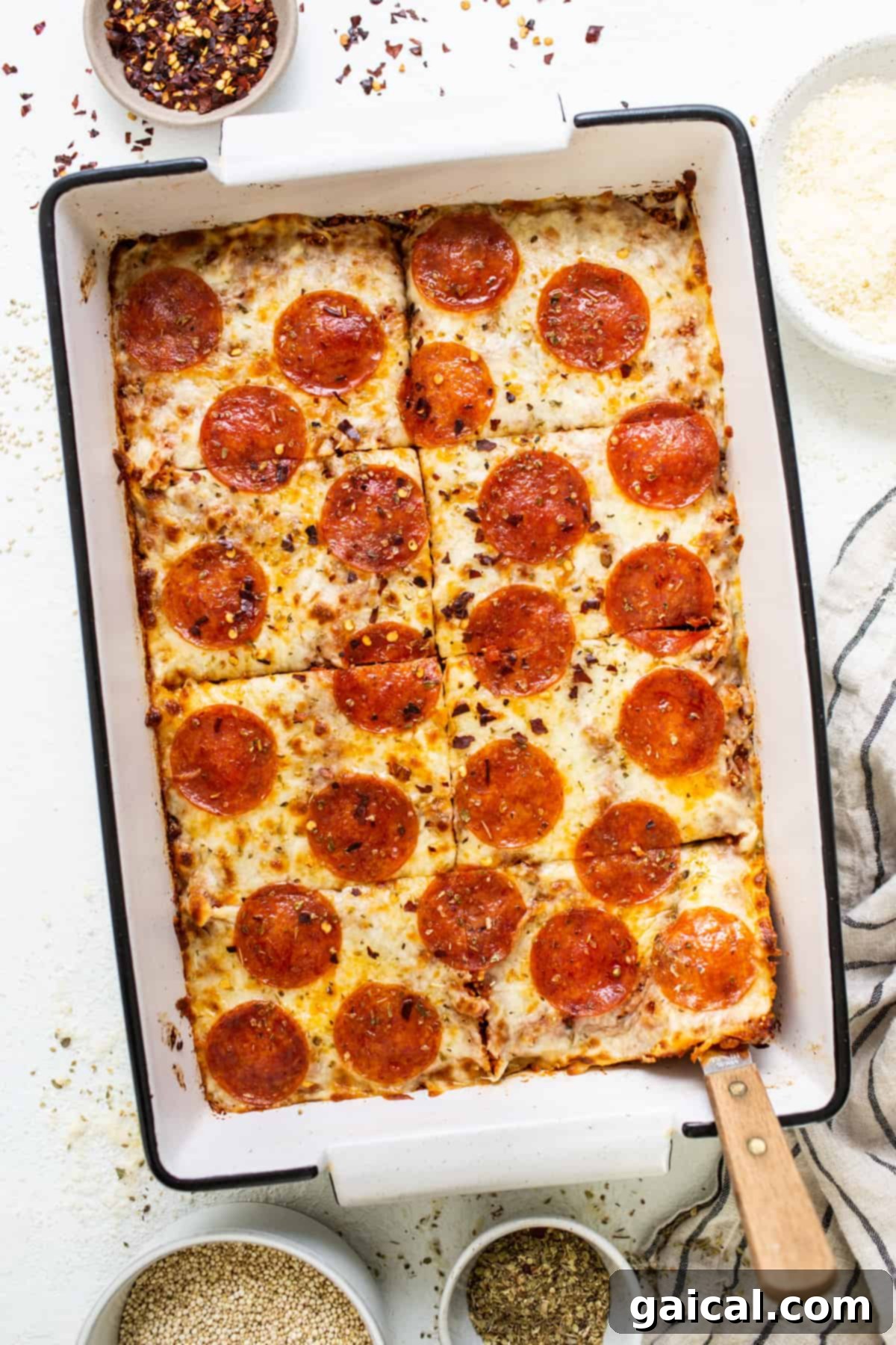 Wholesome Quinoa Pizza Bake 2 Delicious pepperoni pizza quinoa casserole fresh out of the oven in a baking dish, ready to be served.