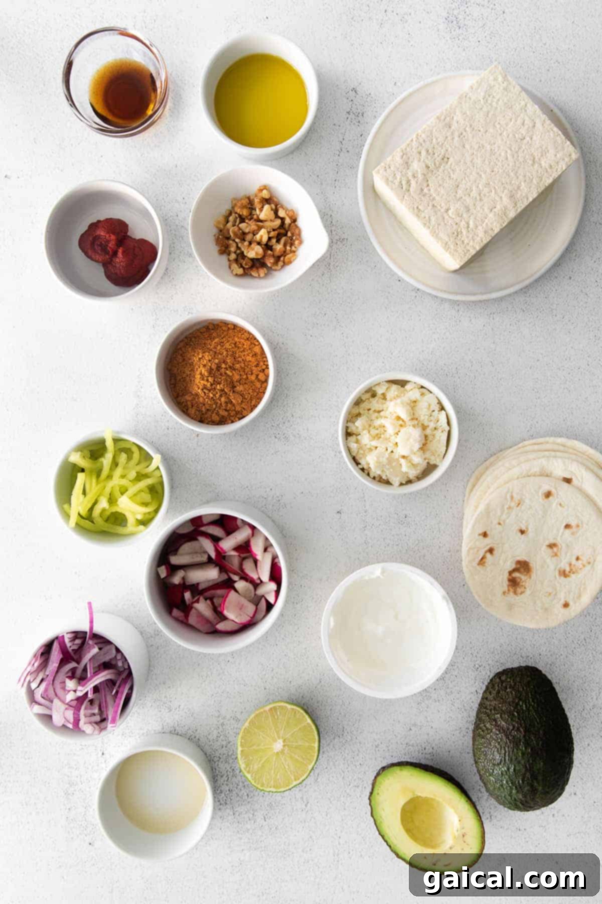 All the vibrant ingredients for tofu tacos, meticulously arranged in small, colorful dishes.