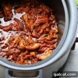 A delicious slow cooker honey sriracha pulled chicken dish, ready to be served.