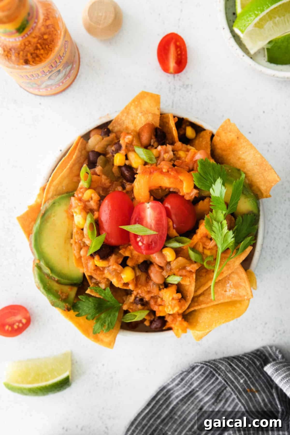 A vibrant bowl of cauliflower taco skillet with avocado and cilantro toppings.