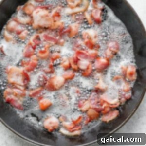 Bacon cooking in a frying pan.
