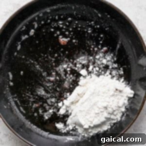 A frying pan with flour in it.