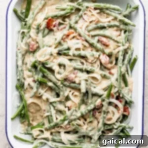 A dish with green beans and bacon in it.