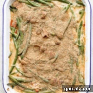 A casserole dish filled with green beans and meat.