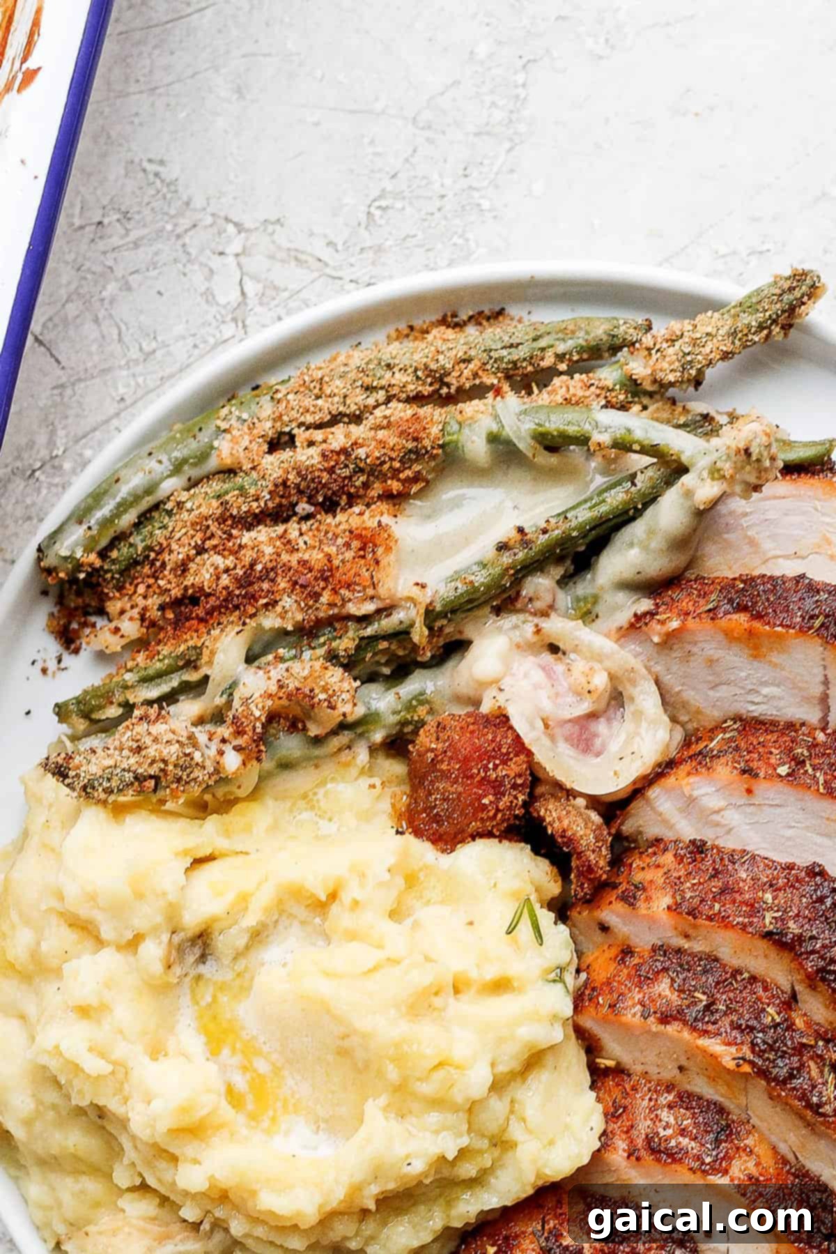 This green bean casserole with bacon is a homemade version of a classic recipe, but instead of using cream of mushroom soup, it features an amazing bacon roux. thanksgiving plate