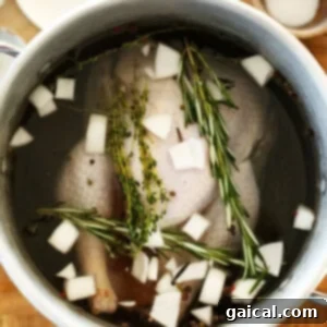 A turkey fully submerged in the smoked turkey brine within a large pot.