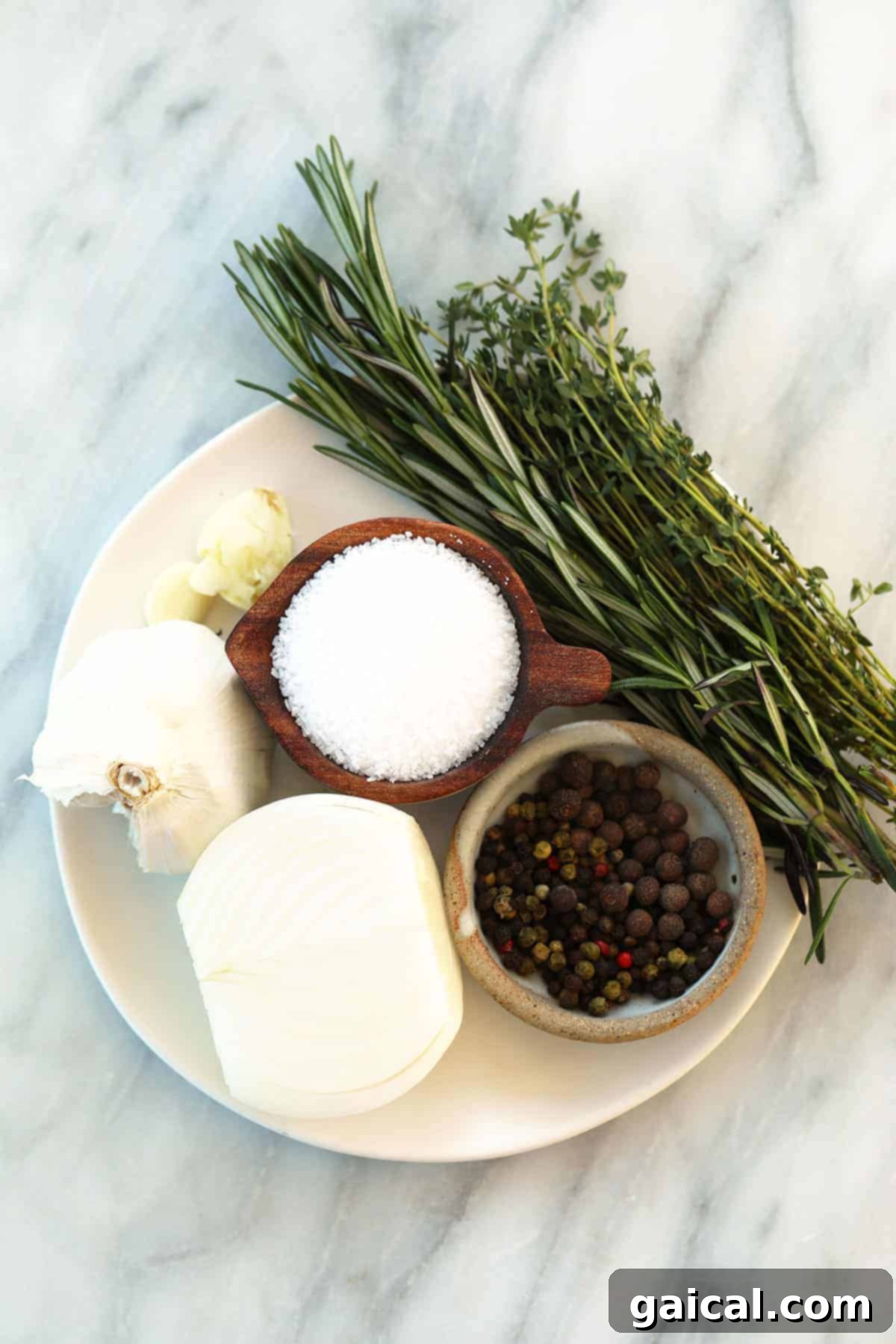 Ultimate Smoked Turkey Brine 3 A vibrant display of fresh herbs, garlic, onion, and coarse salt arranged on a rustic wooden board, showcasing the key ingredients for a homemade smoked turkey brine.