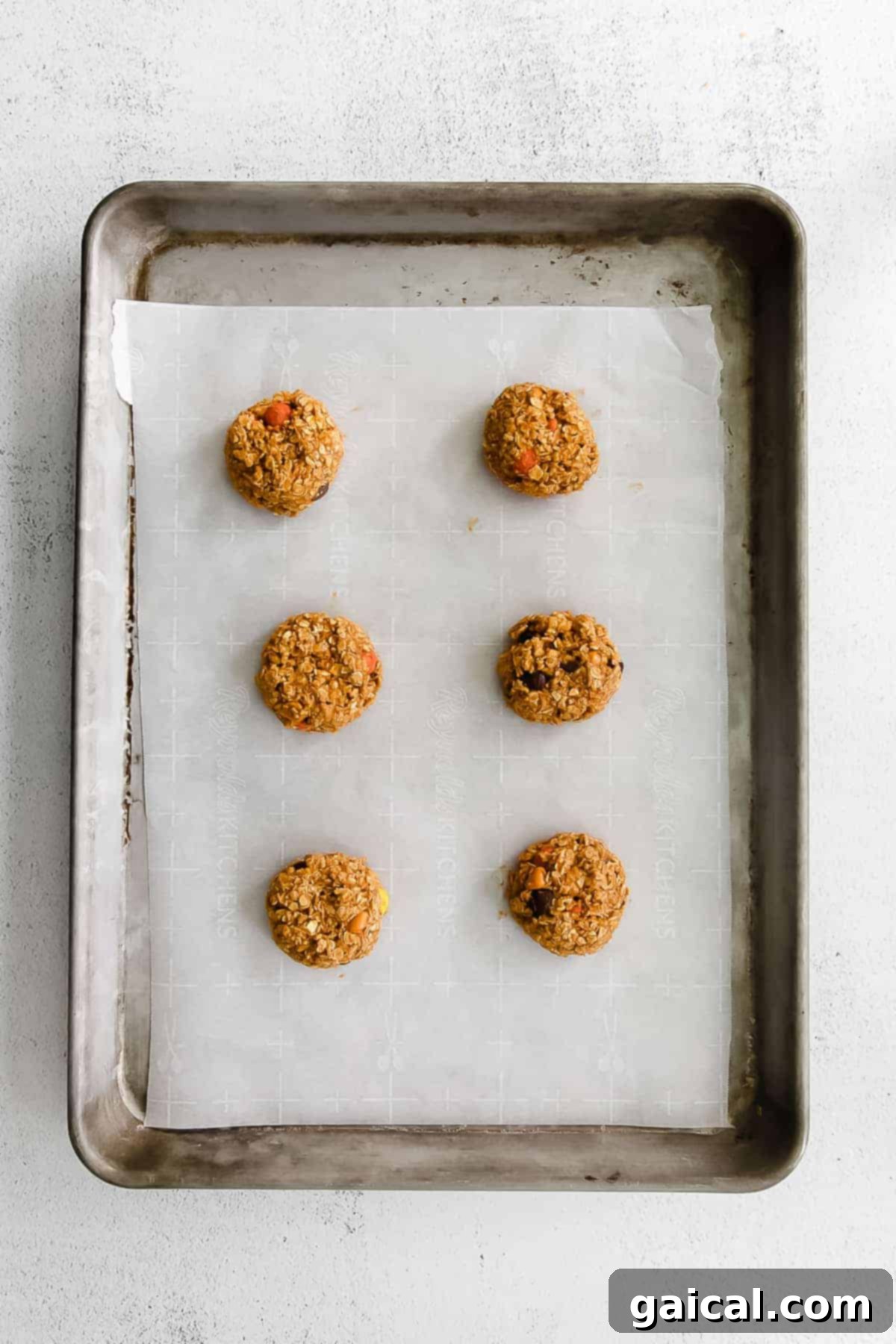 A batch of fall cookies doesn't get much better than Pumpkin Monster Cookies! cookies on a baking sheet, fresh out of the oven