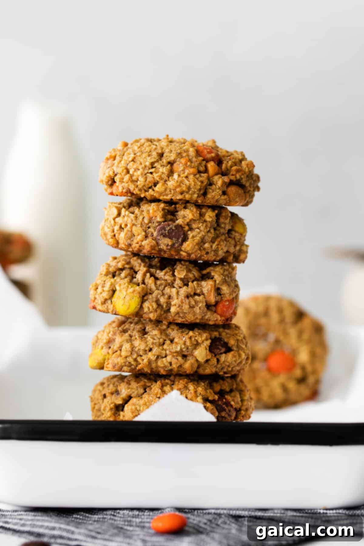 A batch of fall cookies doesn't get much better than Pumpkin Monster Cookies! stack of pumpkin monster cookies, ready to be enjoyed