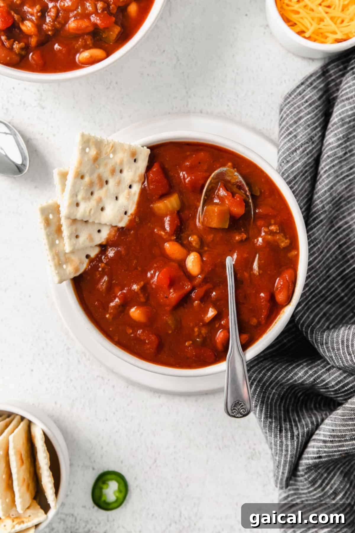 A steaming bowl of homemade Wendy's chili topped with crackers, ready to be enjoyed.