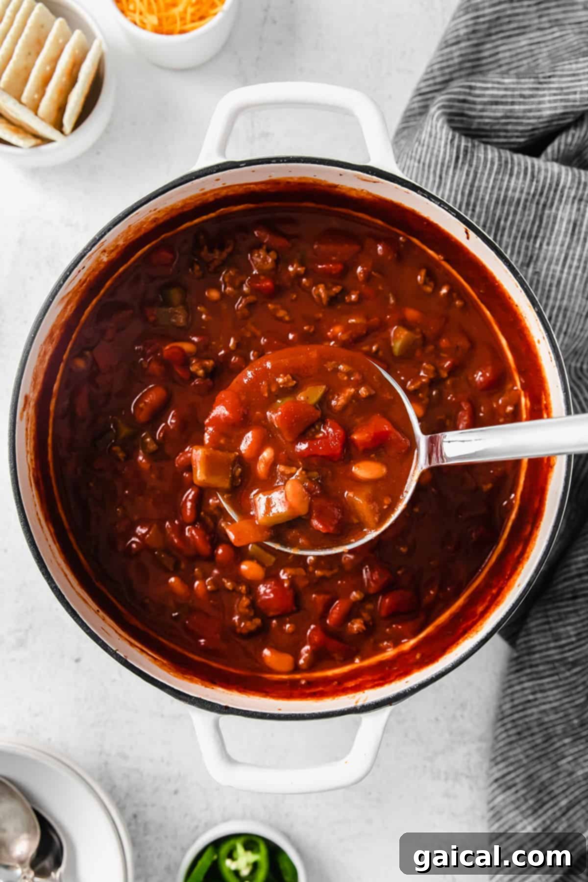 A large pot of Wendy's copycat chili simmering on the stove, steam rising gently.