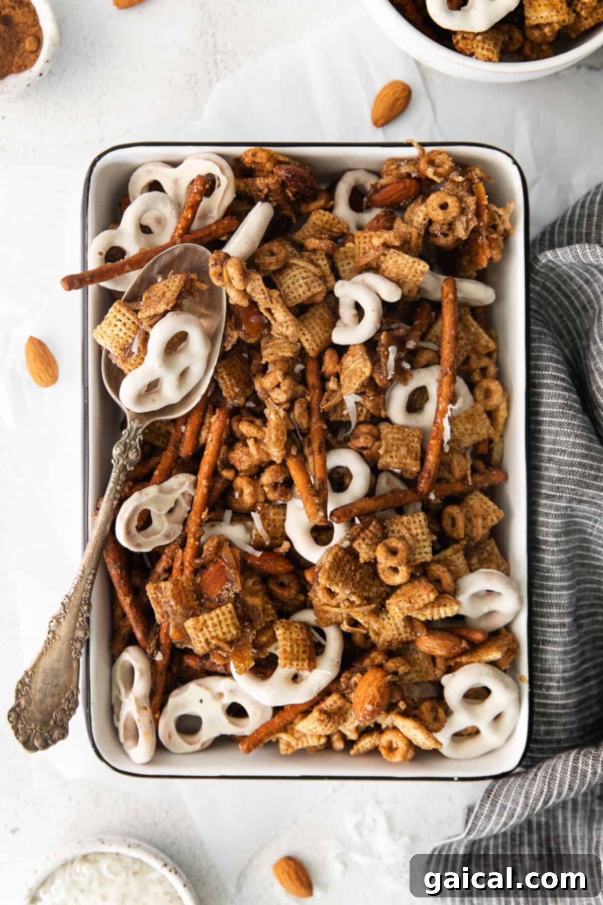 Maple Chai Chex Crunch 2 A close-up shot of delicious Chai Chex Mix in a large pan, showing its perfect golden-brown color and inviting texture. This is the perfect fall snack!