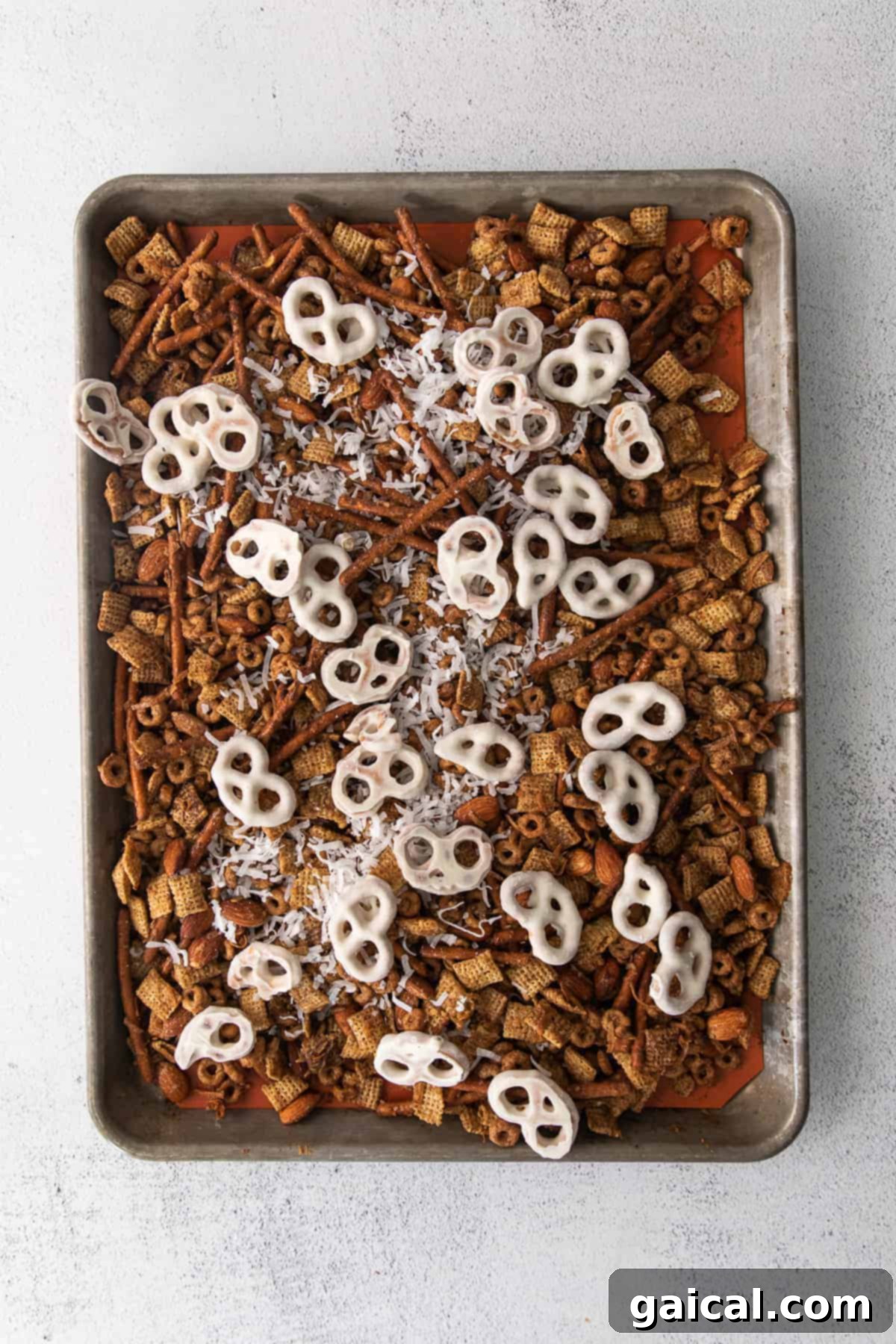 Maple Chai Chex Crunch 7 A large bowl filled with freshly made Chai Chex Mix, showcasing the various textures and colors of its ingredients.