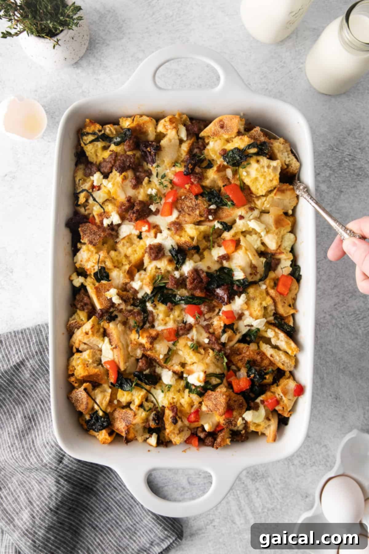 Hearty English Muffin Breakfast Casserole 2 A golden brown English muffin breakfast bake in a ceramic casserole dish, ready to be served.
