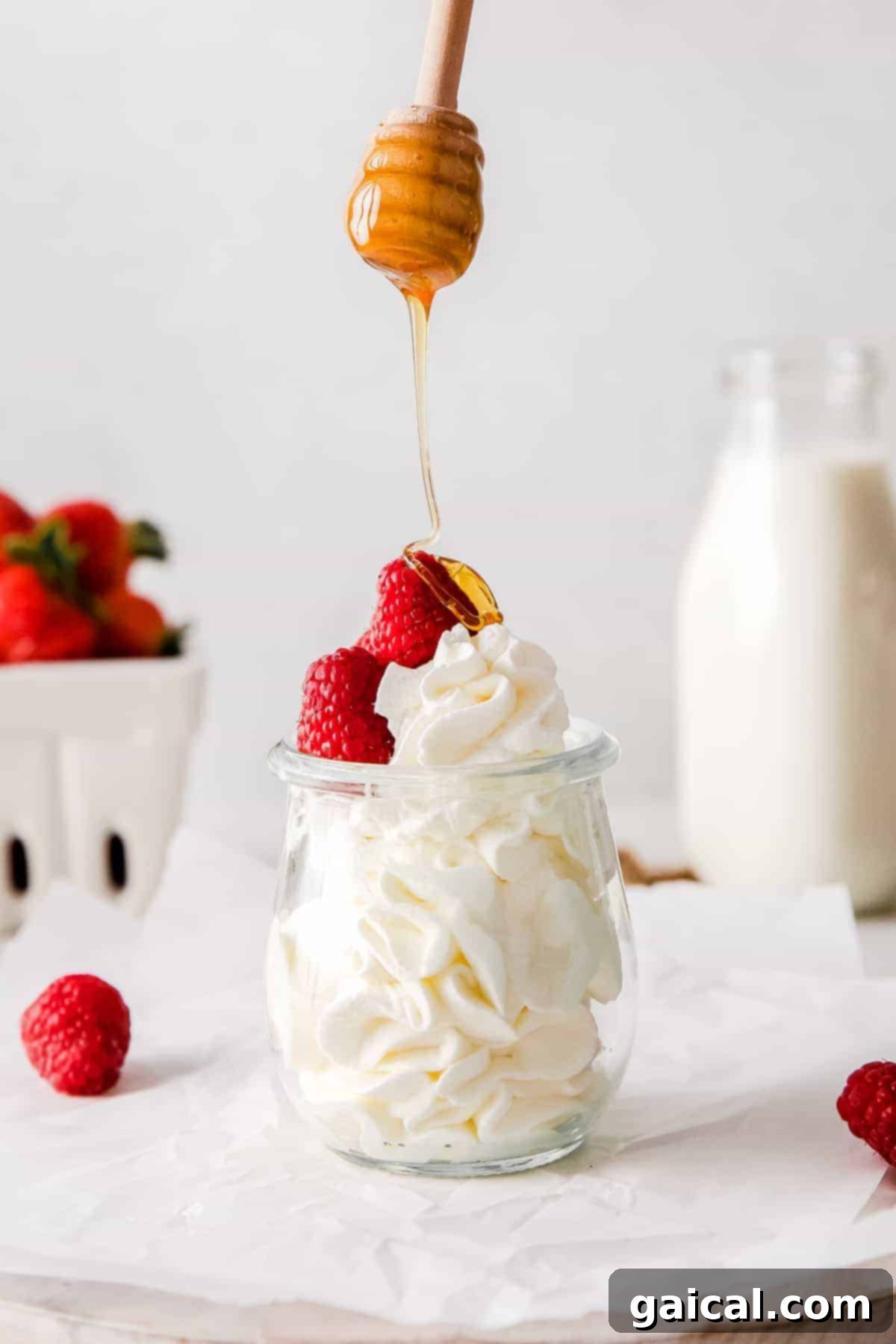 Mastering Whipped Cream from Scratch 2 Drizzling honey over homemade whipped cream.