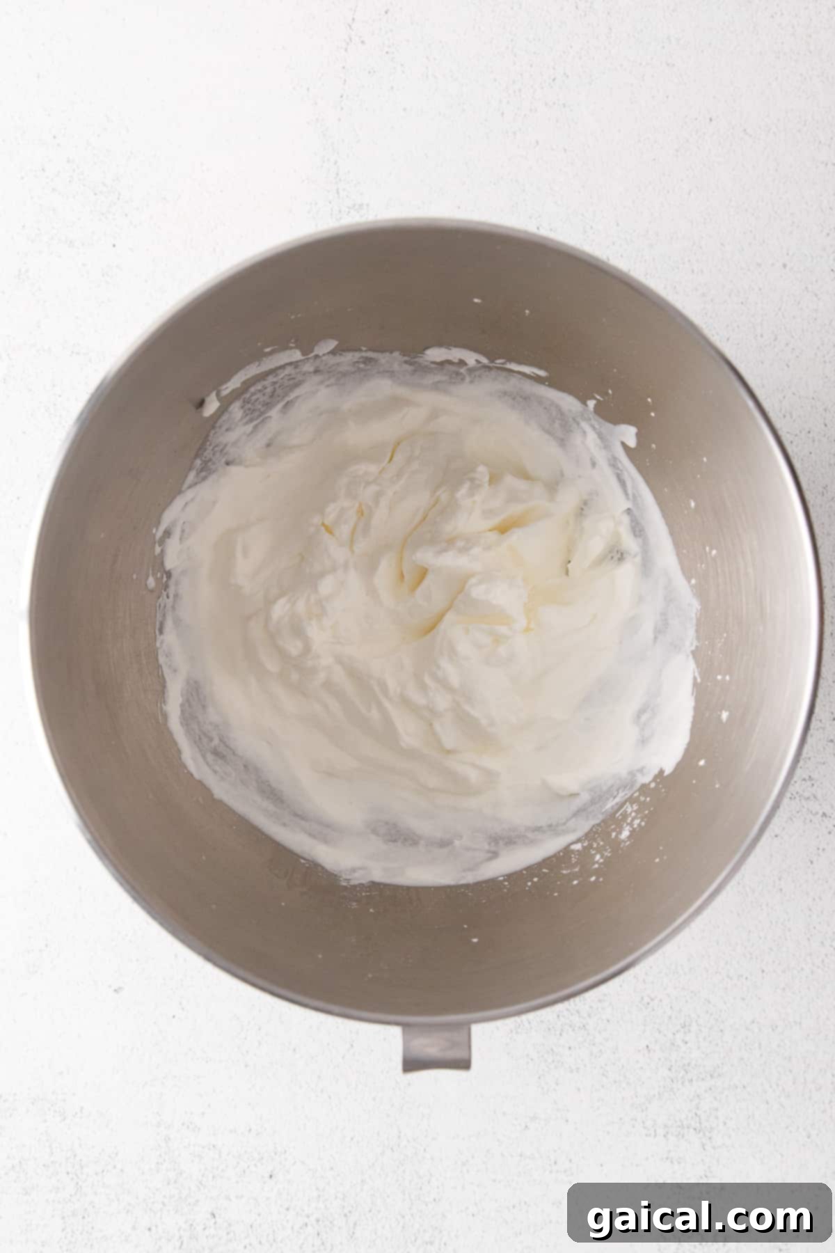 Mastering Whipped Cream from Scratch 3 A bowl of whipped cream in a bowl.