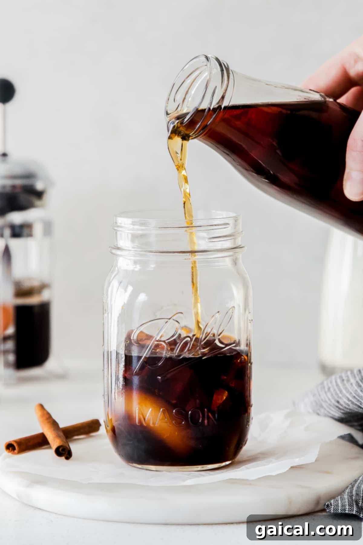 Freshly brewed espresso being poured into a clear glass, ready for mixing.
