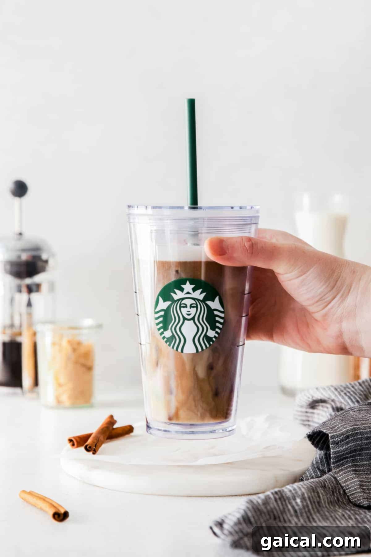 Close-up of the textured, shaken espresso base with ice in a clear glass.