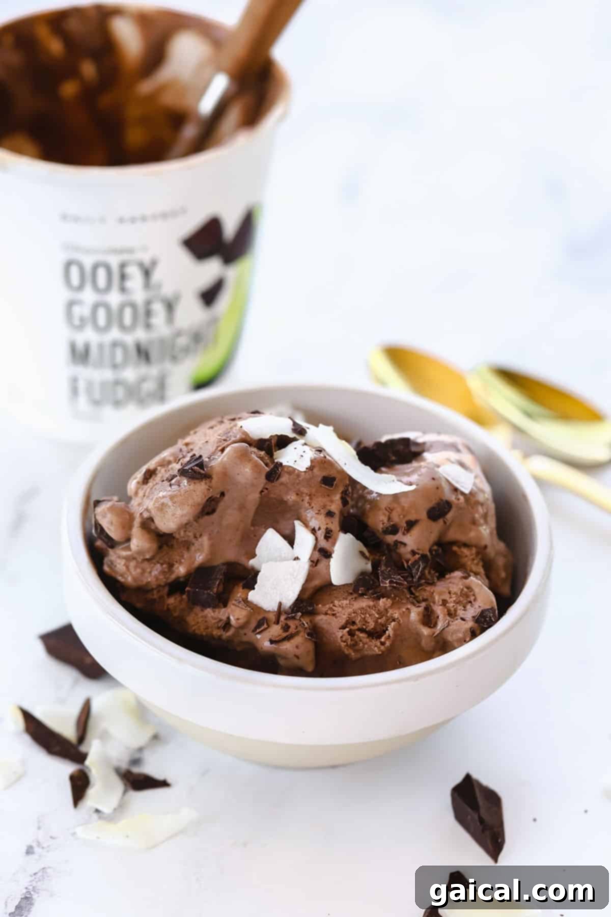 We've been longtime fans of Daily Harvest and their smoothies, so we're thrilled to share our full and honest reviews of ALL of the food in their collections. daily harvest ice cream in a bowl topped with coconut shreds and chunks of chocolate