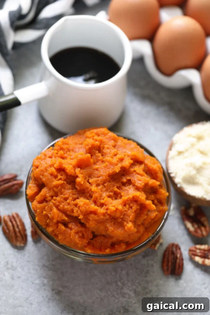 A bowl filled with vibrant orange pumpkin puree, patiently waiting to be incorporated into a batch of fluffy gluten-free pumpkin pancake batter, symbolizing the fresh, natural ingredients used in the recipe.