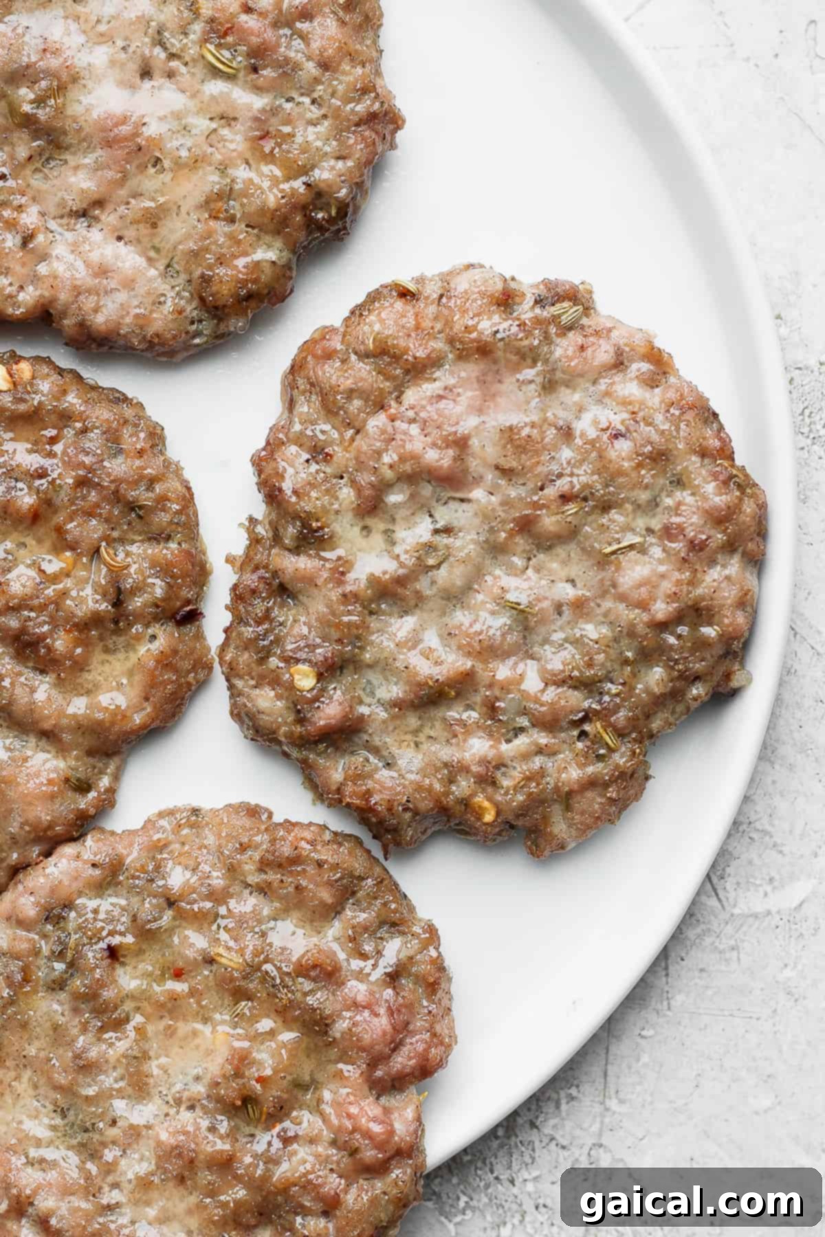 Perfectly cooked breakfast sausage patties on a plate, ready to be served.
