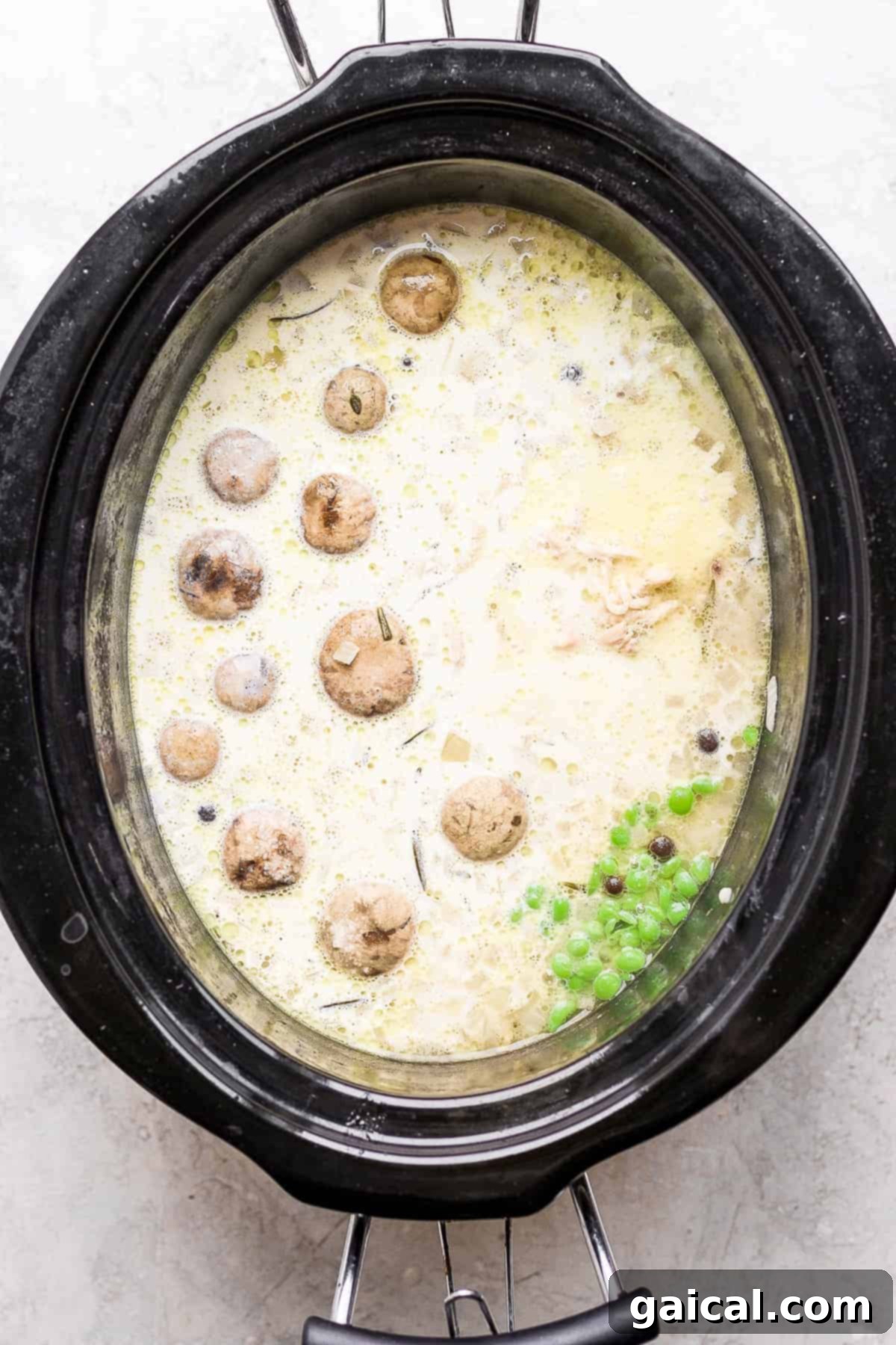 Soul-Warming Slow Cooker Chicken and Dumplings 6 A close-up view of slow cooker chicken and dumplings, showing the thick, creamy broth and fluffy dumplings.